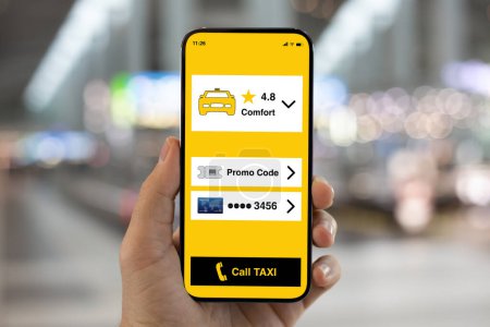 Photo for Male hand hold phone with application call taxi on screen background of lights on street in city - Royalty Free Image