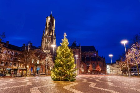 Square with the historical Eusebius church and a christmas tree in Arnhem at night
