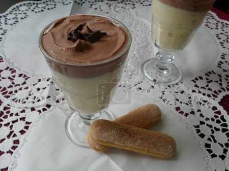 Photo for Vanilla and chocolate pudding with ladyfingers in a glass - Royalty Free Image