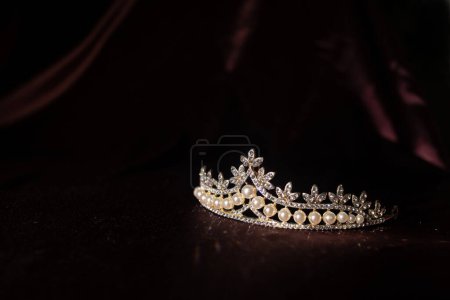 Photo for Luxury vintage diadem with pearls on dark red satin, silk background - Royalty Free Image