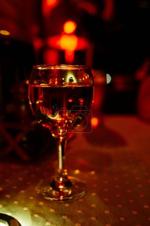 Photo for Glass of wine in red light. Party - Royalty Free Image