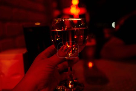 Photo for Glass of wine in hand. Party - Royalty Free Image