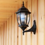 Contemporary street lamp on wooden wall background