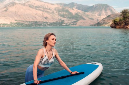 Photo for Woman on sup board. Mountain background. Healthy lifestyle - Royalty Free Image