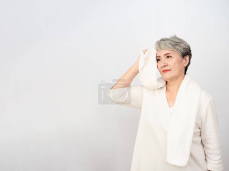 Photo for Portrait of mature aged asian woman 50s with towel at home. - Royalty Free Image