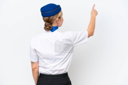 Photo for Airplane blonde stewardess woman isolated on white background pointing back with the index finger - Royalty Free Image