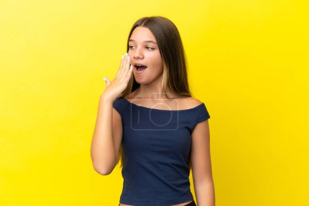 Photo for Little caucasian girl isolated on yellow background yawning and covering wide open mouth with hand - Royalty Free Image
