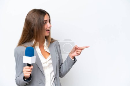 Photo for Young TV presenter caucasian woman isolated on white background pointing finger to the side and presenting a product - Royalty Free Image