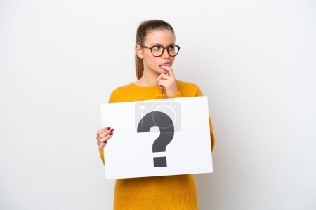 Photo for Young caucasian woman isolated on white background holding a placard with question mark symbol and thinking - Royalty Free Image