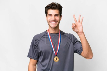 Photo for Young caucasian man with medals over isolated white background happy and counting three with fingers - Royalty Free Image