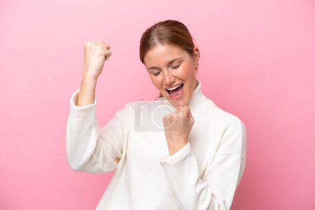 Photo for Young caucasian woman isolated on pink background celebrating a victory - Royalty Free Image