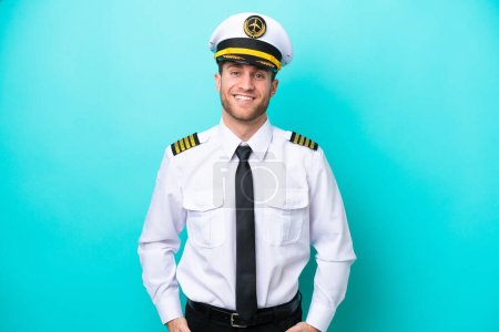 Airplane caucasian pilot isolated on blue background laughing