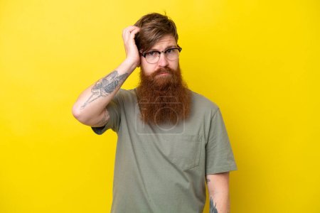 Photo for Redhead man with beard isolated on yellow background with an expression of frustration and not understanding - Royalty Free Image