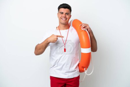 Téléchargez les photos : Young handsome man isolated on white background with lifeguard equipment and pointing lifebuoy - en image libre de droit