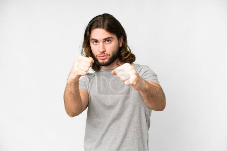 Photo pour Young handsome man over isolated white background with fighting gesture - image libre de droit