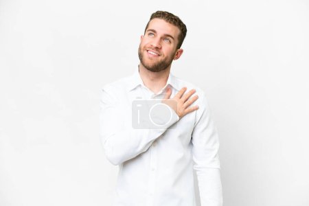 Photo pour Young handsome blonde man over isolated white background looking up while smiling - image libre de droit