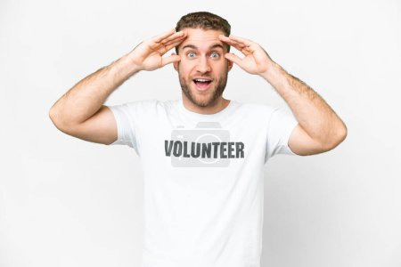 Téléchargez les photos : Young volunteer man over isolated white background with surprise expression - en image libre de droit