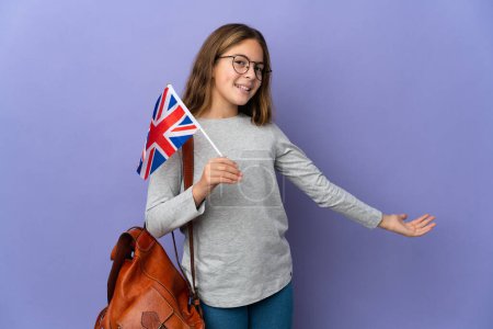 Téléchargez les photos : Child holding an United Kingdom flag over isolated background extending hands to the side for inviting to come - en image libre de droit
