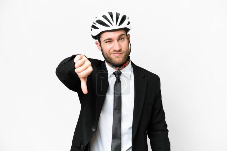 Téléchargez les photos : Business person with a bike helmet over isolated white background showing thumb down with negative expression - en image libre de droit