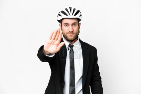 Téléchargez les photos : Business person with a bike helmet over isolated white background making stop gesture - en image libre de droit