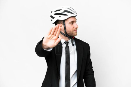 Téléchargez les photos : Business person with a bike helmet over isolated white background making stop gesture and disappointed - en image libre de droit