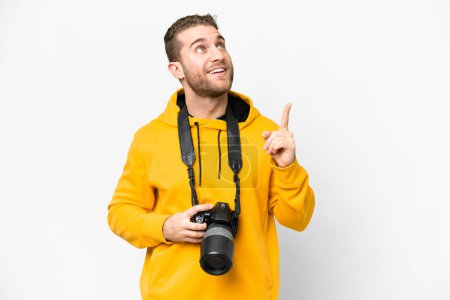 Foto de Young photographer man over isolated white background pointing up and surprised - Imagen libre de derechos