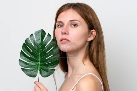 Young English woman holding a palm leaf. Close up portrait