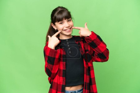 Photo for Little girl over isolated green chroma key background giving a thumbs up gesture - Royalty Free Image