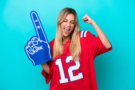 Photo for Uruguayan sports fan woman isolated on blue background celebrating a victory - Royalty Free Image