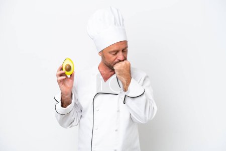 Photo for Chef man holding an avocado isolated on white background having doubts - Royalty Free Image
