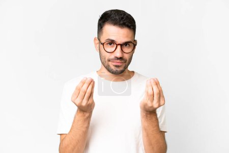 Photo for Young handsome caucasian man over isolated white background making money gesture but is ruined - Royalty Free Image
