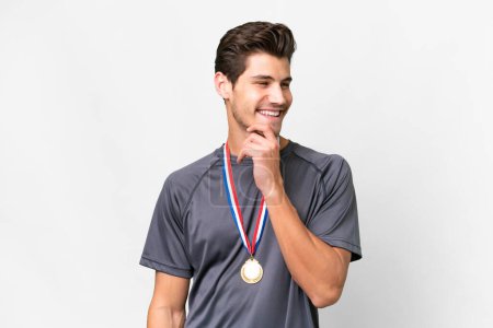 Photo for Young caucasian man with medals over isolated white background looking to the side - Royalty Free Image