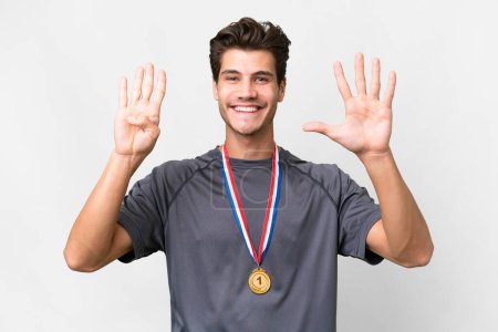 Photo for Young caucasian man with medals over isolated white background counting nine with fingers - Royalty Free Image