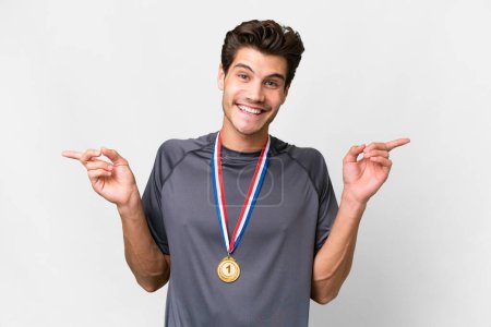 Photo for Young caucasian man with medals over isolated white background pointing finger to the laterals and happy - Royalty Free Image