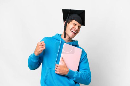 Photo for Young university graduate man over isolated white background celebrating a victory - Royalty Free Image
