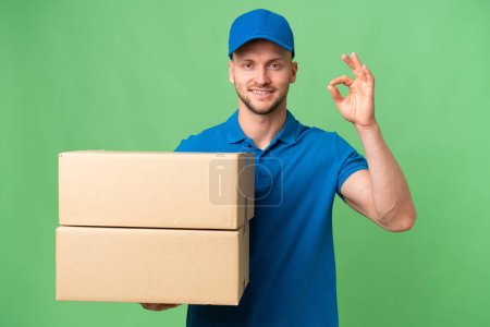 Photo for Delivery caucasian man over isolated background showing ok sign with fingers - Royalty Free Image