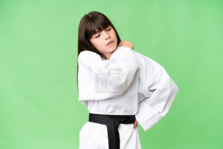 Photo for Little Caucasian girl doing karate over isolated background suffering from pain in shoulder for having made an effort - Royalty Free Image