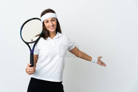 Photo for Young woman tennis player over isolated white background extending hands to the side for inviting to come - Royalty Free Image