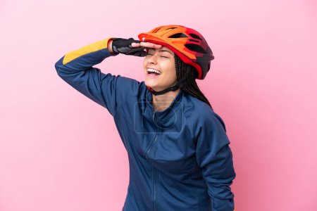 Photo for Teenager cyclist girl isolated on pink background smiling a lot - Royalty Free Image