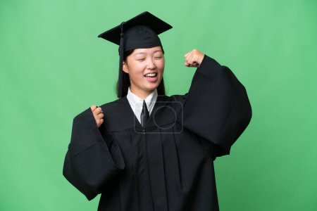 Photo for Young university graduate Asian woman over isolated background celebrating a victory - Royalty Free Image