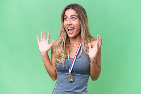 Photo for Young pretty sport Uruguayan woman with medals over isolated background with surprise facial expression - Royalty Free Image