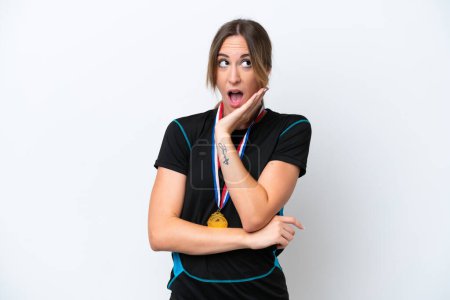 Photo for Young caucasian woman with medals isolated on white background surprised and shocked while looking right - Royalty Free Image