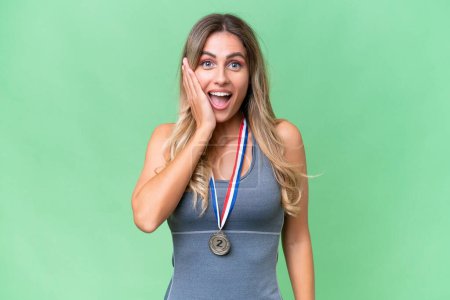 Photo for Young pretty sport Uruguayan woman with medals over isolated background with surprise and shocked facial expression - Royalty Free Image