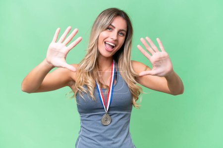 Photo for Young pretty sport Uruguayan woman with medals over isolated background counting ten with fingers - Royalty Free Image