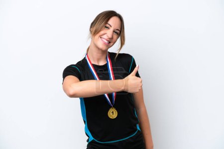 Photo for Young caucasian woman with medals isolated on white background giving a thumbs up gesture - Royalty Free Image