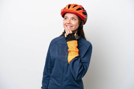Photo for Young cyclist Lithuanian woman isolated on white background looking up while smiling - Royalty Free Image