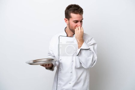 Photo for Young caucasian chef with tray isolated on white background having doubts - Royalty Free Image