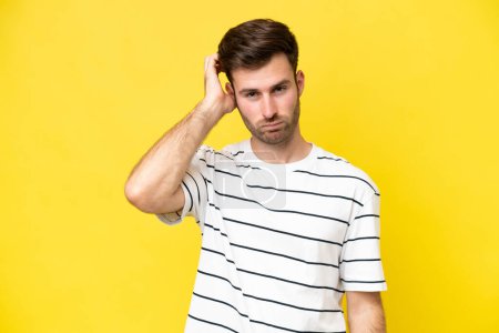Photo for Young caucasian man isolated on yellow background with an expression of frustration and not understanding - Royalty Free Image