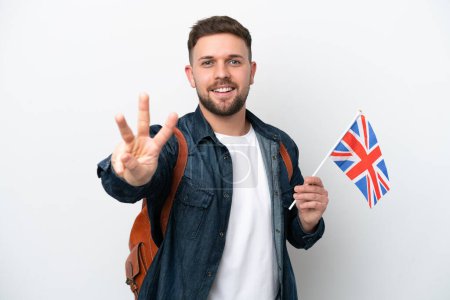 Photo for Young caucasian man holding an United Kingdom flag isolated on white background happy and counting three with fingers - Royalty Free Image