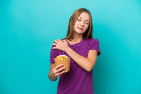 Photo for Young Russian woman catching french fries isolated on blue background suffering from pain in shoulder for having made an effort - Royalty Free Image